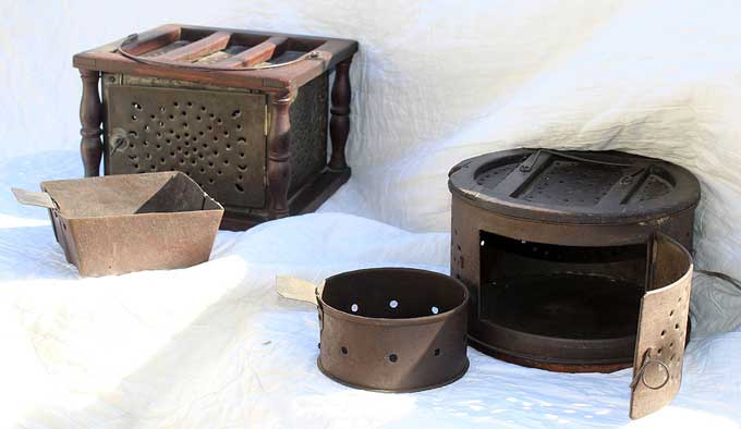 Foot Warmers - A large foot warmer alongside a rare round foot warmer with their respective metal boxes to contain the coals.
