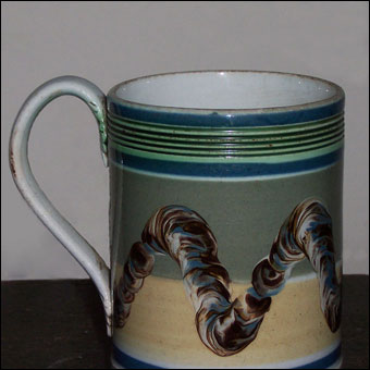 Mochaware - Pearlware pint mug with common cable or earthworm decoration and rilling at the rim. Found in Huntingdon County, Pennsylvania and sold for $3,000 to a private collector a few years ago.
