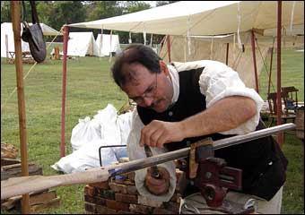 Washingtonburg, PA - Gunsmith filing the barrel of a rifle
